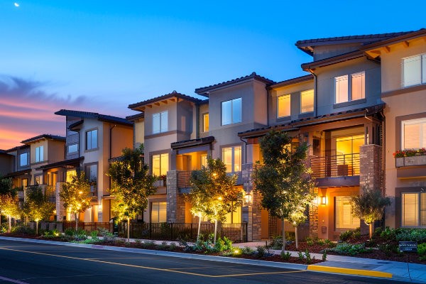 Luxury apartment buildings at dusk with warm lighting